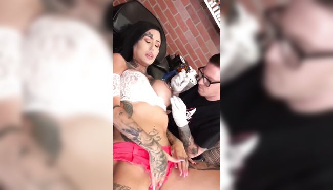 Big boobs baby plays with her pussy while getting nipple tattoo