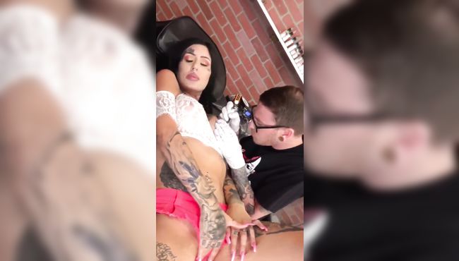 Big boobs baby plays with her pussy while getting nipple tattoo