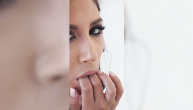 Hot brunette babe performs a striptease outdoors